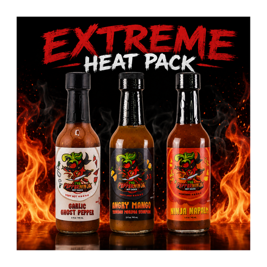 Three bottles of hot sauce from Hell's Kitchen's Extreme Heat Pack are displayed against a fiery background. The bottles are labeled Garlic Ghost Pepper, Angry Mango, and Ninja Nappa, with red and orange flames flanking them.